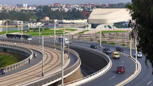 Cars driving on Hassan II bridge with a view over the Grand Theatre of Rabat in Morocco