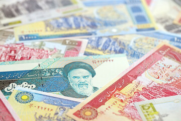 Big pile of Iranian Rial IRR banknotes from Iran as the background on flat surface close up