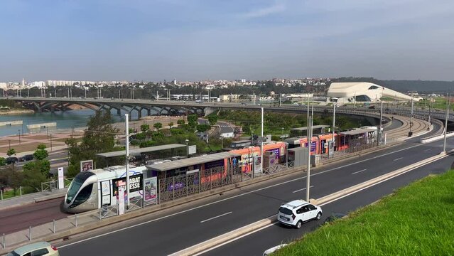 Modern tram passing by the Bou Regreg river with a view over the Grand Theatre of Rabat in Morocco