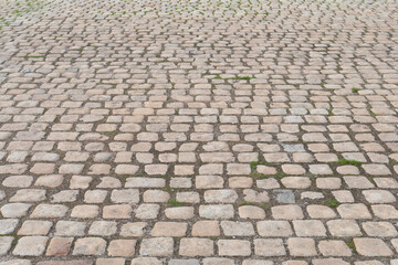 Old cobbled stone path floor outdoors, warm color, background pattern in perspective