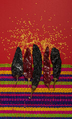 Dried Chilis Red background  mexican tablecloth Pasilla and Guajillo mexican spice