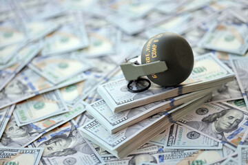 Grenade with a check against the background of huge amount of american dollar bills close up