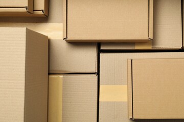 Many cardboard boxes as background, top view. Packaging goods