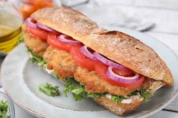 Delicious sandwich with schnitzel on white wooden table, closeup