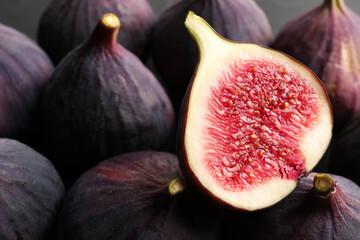 Whole and cut fresh figs as background, closeup view