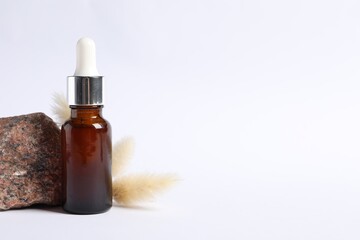 Fototapeta premium Composition with bottle of cosmetic serum on white background. Space for text