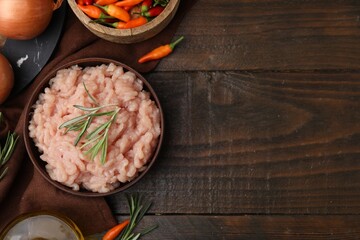 Flat lay composition with fresh raw minced meat and products on wooden table. Space for text