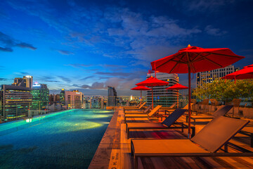 swimming pool and roof top bar on hotel deck in Bangkok city