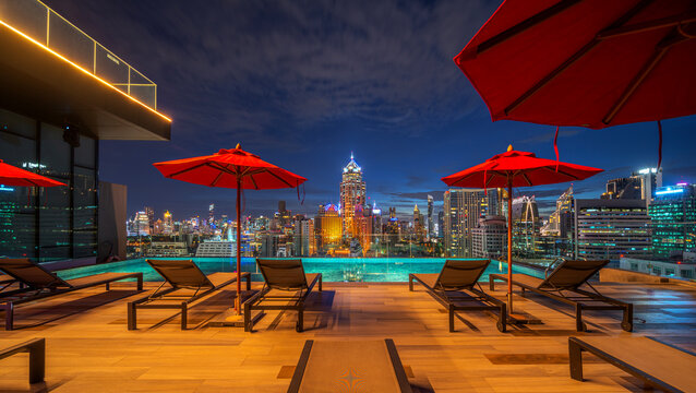 swimming pool and roof top bar on hotel deck in Bangkok city