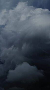 Lot of lightning during a thunderstorm. Storm clouds are moving fast on the viewer, timelapse. Vertical video
