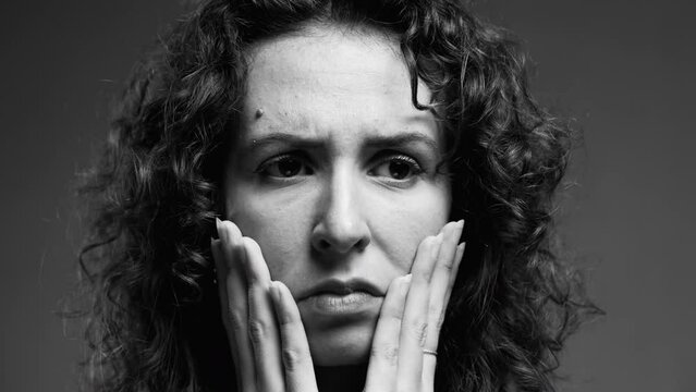 Woman in crisis struggling with mental disorder captured in black and white monochromatic. Portrait of person struggling with anxiety and despair