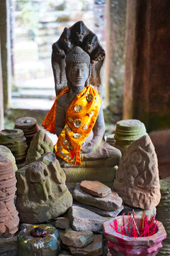 Buddha idol being worshipped inside the Bayon Temple - Masterpiece of Khmer Architecture built as a Buddhist temple by Jayavarman VII at Siem Reap, Cambodia, Asia