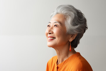 Side view of senior asian woman smile studio shoot - obrazy, fototapety, plakaty