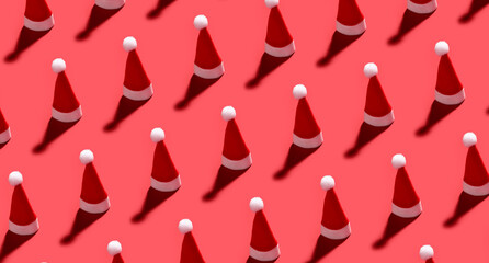 Many Santa hats on red background. Pattern for design