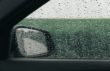 a wet car window with raindrops