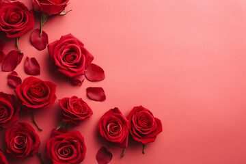 Red roses over a pink background flat lay. Valentine's Day, Birthday abstract background with copy space