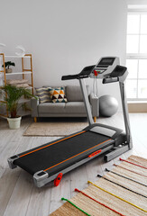 Modern treadmill in interior of living room