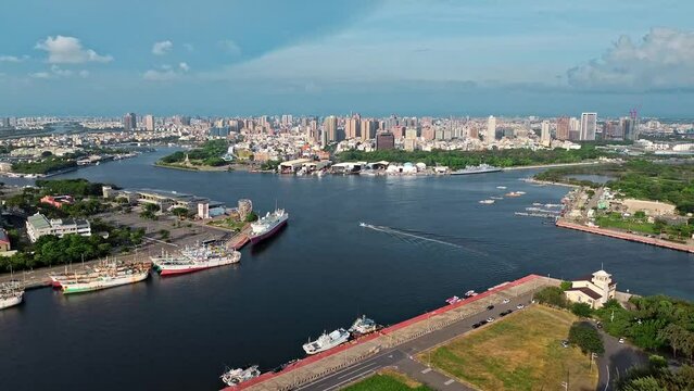 Aerial 4k footage of Tainan city with river crossing in the middle and boats in Taiwan.