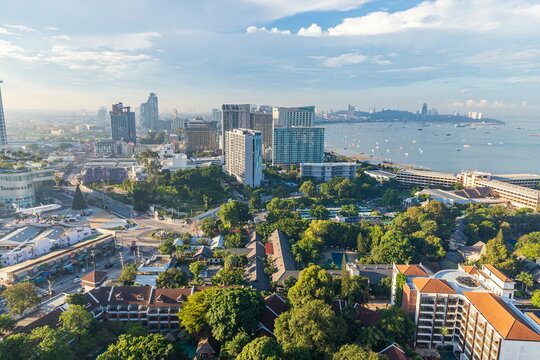 Chonburi, Thailand - 26 Oct. 2023 ; Morning view of Pattaya city Many tall buildings from above Dolphin circle area The picture is divided into halves road and sea can see the city to Bali Hai Pier.