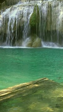 One of the waterfalls of the Erawan cascade in Kanchanaburi province, Thailand. Vertical video
