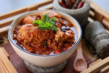 Spicy red chicken curry. Goan style chicken vindaloo. Butter chicken Murgh Makhani curry roast hot and spicy gravy dish Dhaba Punjab, India. North Indian non-vegetarian cuisine Garam Masala. tikka