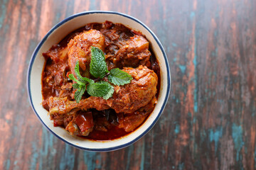 Spicy red chicken curry. Goan style chicken vindaloo. Butter chicken Murgh Makhani curry roast hot and spicy gravy dish Dhaba Punjab, India. North Indian non-vegetarian cuisine Garam Masala. tikka