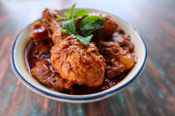 Spicy red chicken curry. Goan style chicken vindaloo. Butter chicken Murgh Makhani curry roast hot and spicy gravy dish Dhaba Punjab, India. North Indian non-vegetarian cuisine Garam Masala. tikka
