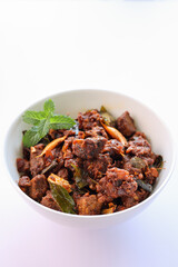Kerala style beef or Mutton dry fry. delicious spicy Beef fry in clay pot . beef curry for ghee rice, kappa, appam, parotta, puttu, bread and chappathi, beef roast. Indian cuisine .