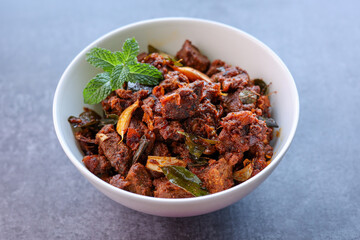 Kerala style beef or Mutton dry fry. delicious spicy Beef fry in clay pot . beef curry for ghee...