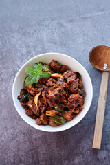 Kerala style beef or Mutton dry fry. delicious spicy Beef fry in clay pot . beef curry for ghee rice, kappa, appam, parotta, puttu, bread and chappathi, beef roast. Indian cuisine .