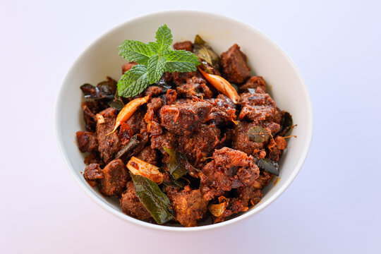 Kerala style beef or Mutton dry fry. delicious spicy Beef fry in clay pot . beef curry for ghee rice, kappa, appam, parotta, puttu, bread and chappathi, beef roast. Indian cuisine .
