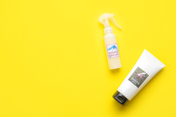 Mosquito repellent cream and spray on yellow background