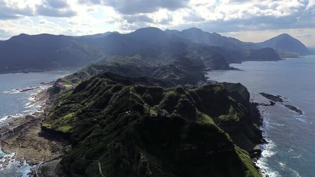 Aerial 4k footage of Bitoujiao lighthouse, a famous scenery of Taiwan northeast corner. Birds eye view in Bitoujiao cape, Ruifang district, New Taipei, Taiwan.
