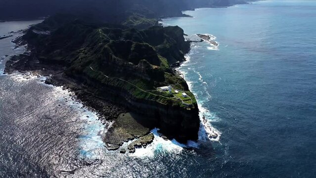 Aerial 4k footage of Bitoujiao lighthouse, a famous scenery of Taiwan northeast corner. Birds eye view in Bitoujiao cape, Ruifang district, New Taipei, Taiwan.