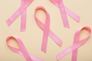 Pink ribbons on beige background. Breast cancer awareness concept