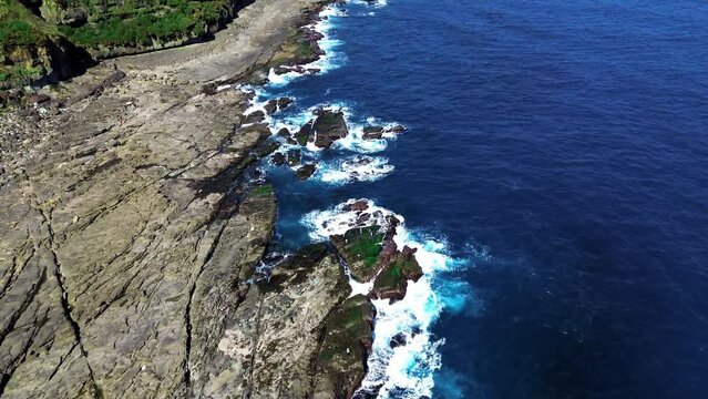 Aerial 4k footage of Bitoujiao lighthouse, a famous scenery of Taiwan northeast corner. Birds eye view in Bitoujiao cape, Ruifang district, New Taipei, Taiwan.