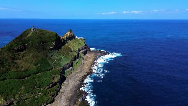 Aerial 4k footage of Bitoujiao lighthouse, a famous scenery of Taiwan northeast corner. Birds eye view in Bitoujiao cape, Ruifang district, New Taipei, Taiwan.