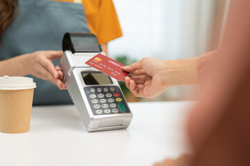 Pay, cashless technology concept, hand of customer using credit card for terminal payment, paying money to transfer cashless at cafe grocery retail shop to buy breakfast, holding wireless bank machine - obrazy, fototapety, plakaty