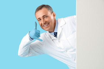 Mature doctor with blank poster showing 