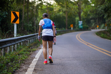A runner is tired from running uphill in an ultra race.