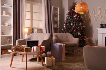 Interior of living room with Christmas tree, armchairs and shopping bags