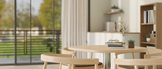 Copy space on a minimal wooden round table in a modern bright living room. close-up image