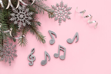 Composition with note signs, fir branches and Christmas decorations on color background