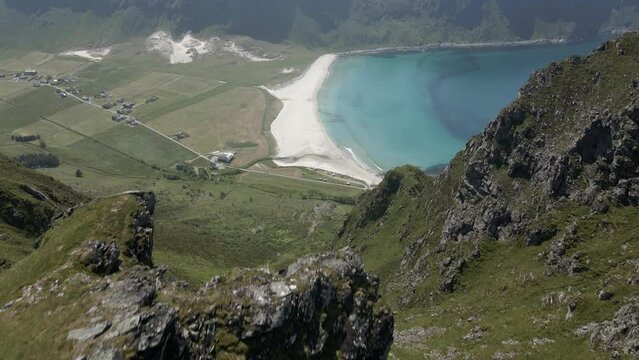 Aerial top down shot Hoddevik mountains and sandy beach with turquoise Water of ocean in Norway - Tilt up drone shot