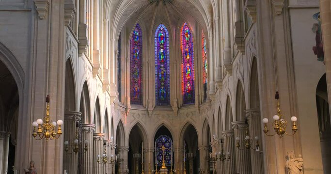 Tilt up shot of dimly lit alter in the interior of a roman catholic church of Saint-Germain-l'Auxerrois in Paris, France. 4K.