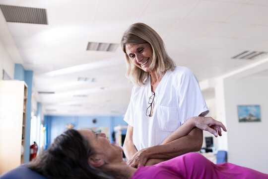Focused photo on the face of the blonde nurse standing next to her patient.