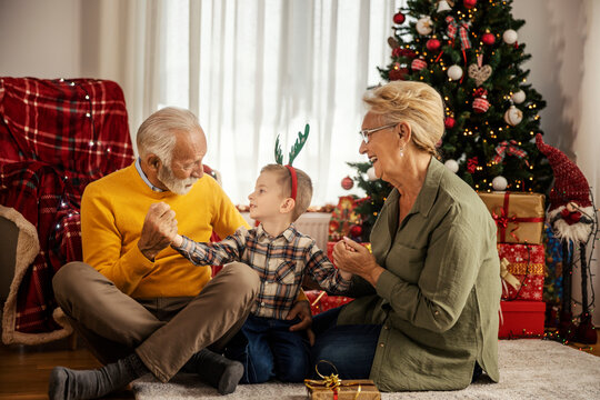 Grandparents are spending time with their grandson at home on christmas and new year.