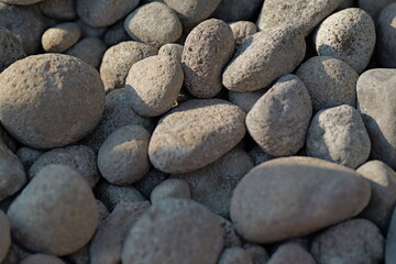 Fototapeta na wymiar Gravel texture. Pebble stone background. Light grey closeup small rocks. Top view of ground gravel road.