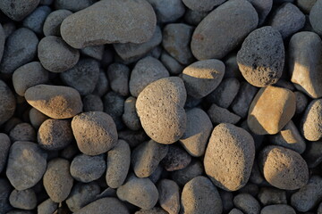 Fototapeta na wymiar Gravel texture. Pebble stone background. Light grey closeup small rocks. Top view of ground gravel road.