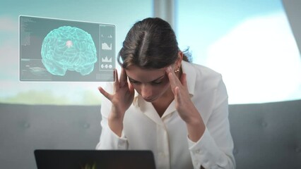 Young successful businesswoman works exhausted with headache on laptop screen. Digital animation of the brain with reference to the pain center